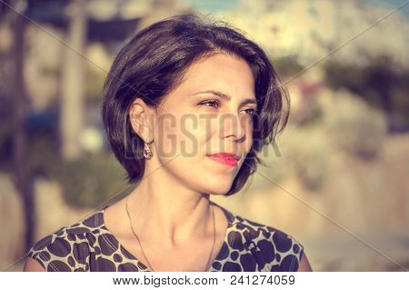 Brunette Girl On The Coast Of The Mediterranean Sea, Looks Into The Distance.