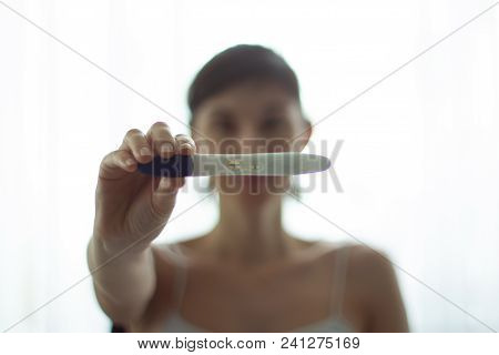 Young Woman With Pregnancy Test In Hands. The Test Shows A Positive Result