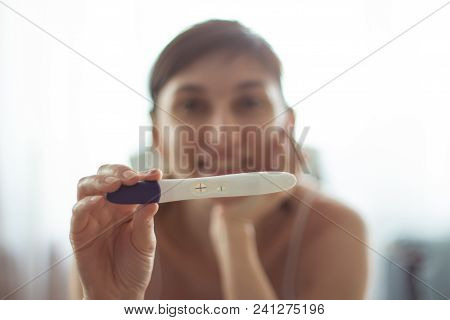 Young Woman With Pregnancy Test In Hands. The Test Shows A Positive Result
