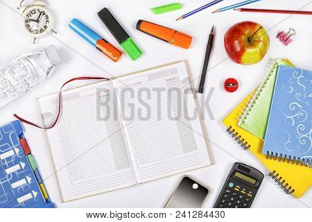 Back To School. Top View Of Open Notebook With Pencil, Colourful Pushpins, Caculator, Cell Phone And