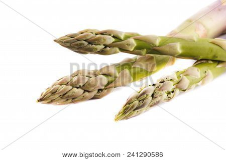 Green fresh asparagus sprouts isolated on white background.