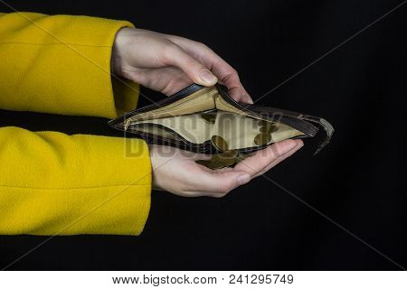 Girl Pours Out Coins From A Purse, Black Background, Close-up