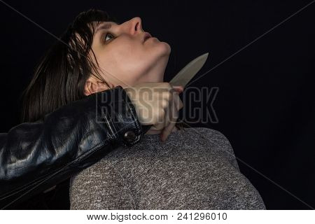 A Man Put A Knife To The Girl's Throat, A Black Background