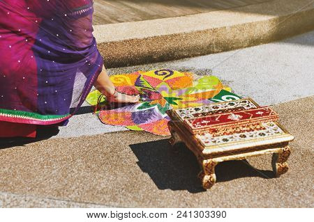 Women Coloring Tradition Colorful Rice Art Or Sand Art (rangoli) On The Floor With Paper Pattern Usi