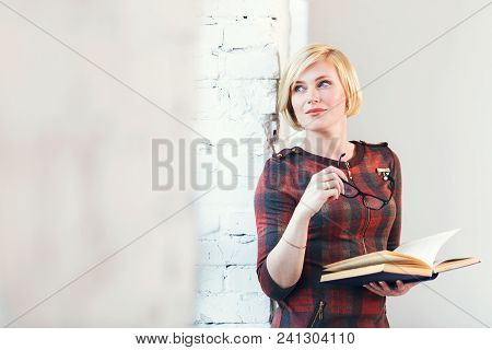Pretty Intelligent Blonde Woman Wears Eyeglasses And Red Dress Reading Book Near Wide Window In Lagh