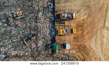 A Lot Of Waste Is Disposed Of In The Waste Disposal Pits. Loaders Is Working On A Mountain Garbage. 