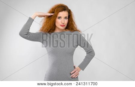 Charming Young Girl With Red Hair. A Young Girl In A Gray Sweater. Young Girl On A Gray Background.