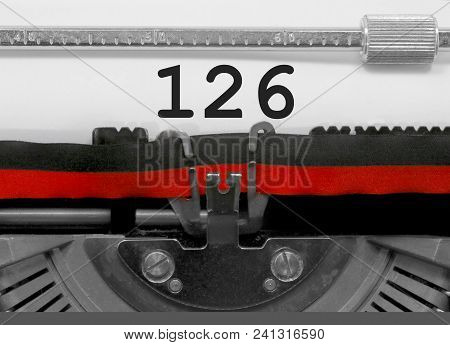 126 Number Text Written By An Old Typewriter On White Sheet