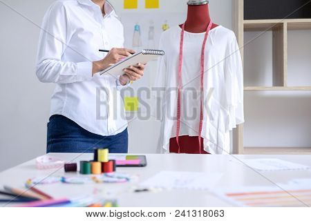 Stylish Fashion Designer Working With Measure Red Dummy As Sketches In Draft Book Of New Collection 
