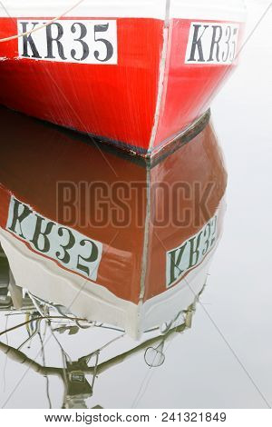 Borgholm, Sweden - Apr 28 2018: Closeup Of Red Fishing Boat Reflecting In The Water In The City Borg