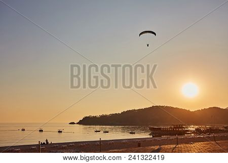 Paraglider Silhouette Flying Over Misty Mountain Valley In Beautiful Warm Sunset Colors - Sport, Act