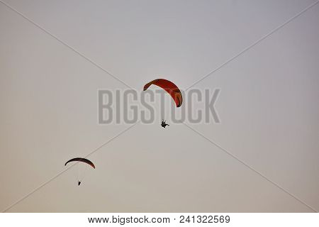 Paraglider Silhouette Flying Over Misty Mountain Valley In Beautiful Warm Sunset Colors - Sport, Act