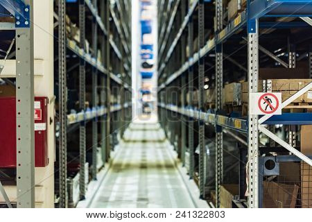 Defocused Image Of Tiered Storage Facility At Machinery Industrial Plant. Factory Warehouse With Spa