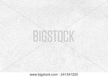 Abstarct Background From Cracked Texture On White Ceramic Plate.