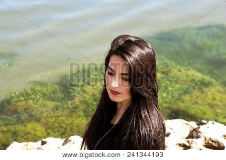 Happy Woman On The Beach. Portrait Of A Beautiful Girl Close-up. Spring Portrait On The Beach. Young