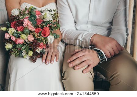 Hands Of The Bride And Groom, The Girl Holding A Bouquet
