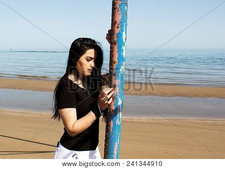 Happy Woman On The Beach. Portrait Of A Beautiful Girl Close-up. Spring Portrait On The Beach. Young