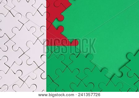 Madagascar Flag  Is Depicted On A Completed Jigsaw Puzzle With Free Green Copy Space On The Right Si
