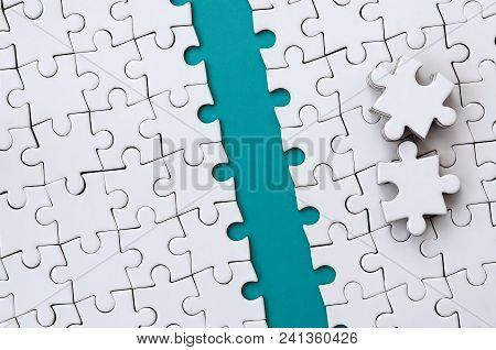 The Blue Path Is Laid On The Platform Of A White Folded Jigsaw Puzzle. The Missing Elements Of The P