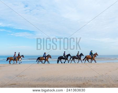 Kijkduin, The Hague, The Netherlands - May 12 2018: Group Of Horse Riders On The Beach