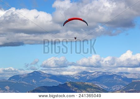 Paraglider Flying N The French Alps From The Chabre