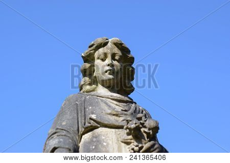 Close Up Picture Of A Statue In Graveyard