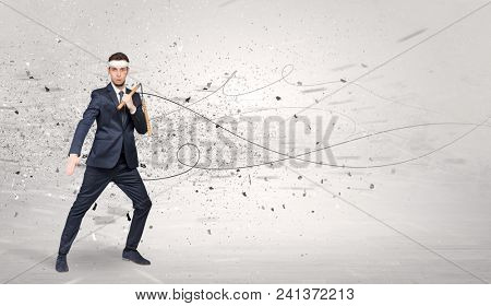 Young suited karate trainer doing karate tricks with chaotic concept