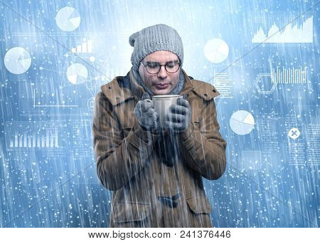 Young businessman shivering with graphs, reports and chart concept