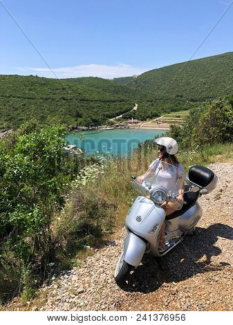 Girl On Scooter Near Ploce Beach; Montenegro.
