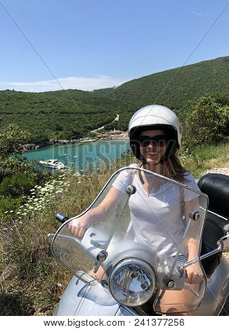 Girl On Scooter Near Ploce Beach; Montenegro.