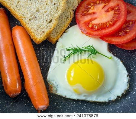 Breakfast Fried Egg In Heart-shaped, Grilled Sausages, Bread, Fresh Dill, In The Pan, Top View, Dark