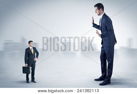 Giant businessman being afraid of small serious executor with suitcase