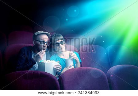 Teenager couple cuddling and watching the climax part of the movie