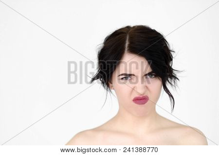 Emotion Face. Bad Smell And Stinky Rancid Odour Disgust Concept. Young Beautiful Brunette Girl Portr
