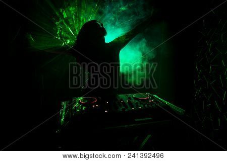 Dj Spinning, Mixing, And Scratching In A Night Club, Hands Of Dj Tweak Various Track Controls On Dj'