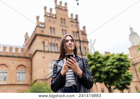 Cute Young Female College Student Using Smart Phone Browsing Internet