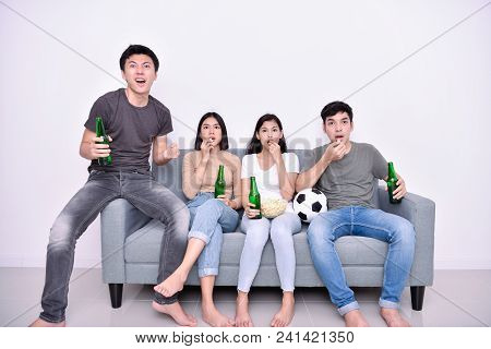 Concept Of Cheering. Asian Teenagers Watching Football On Television. People Are Cheering And Winnin
