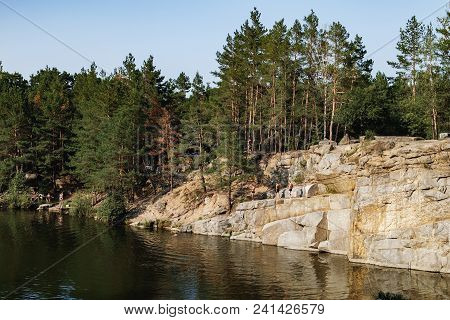 Korostyshiv, Ukraine - August 15, 2017: People Have Rest And Swim On The Lake In The Middle Of A Con