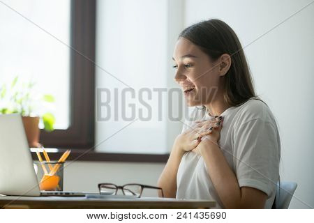 Smiling Female Worker Happily Looking At Laptop Screen, Satisfied With Online Lottery Win, Successfu