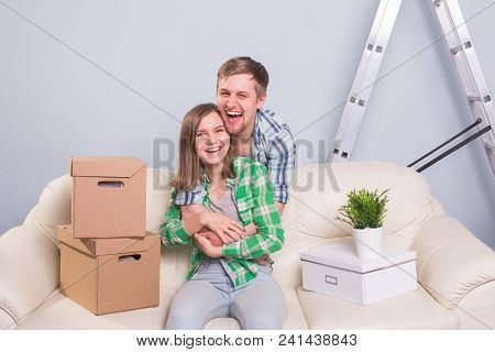 Young Cheerful Couple Moving Into Their New Home.