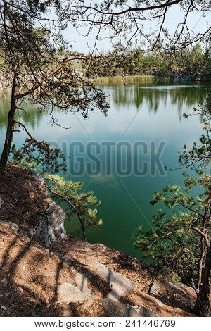 Picturesque Landscape With A Lake In The Middle Of A Coniferous Forest In Korostyshiv Quarry, Zhytom