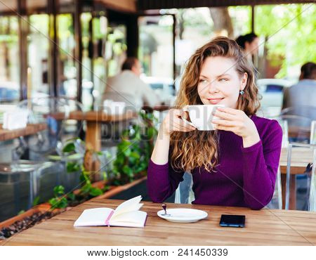 Beautifl Attractive Young Blonde Woman With Curly Hair Drinking Cappuccino In City Cafe Summer Day. 