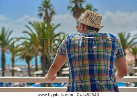 Man In Sunhat Watching At Beautiful Sea View. Back View. Santa Susanna. Cataluna. Spain.