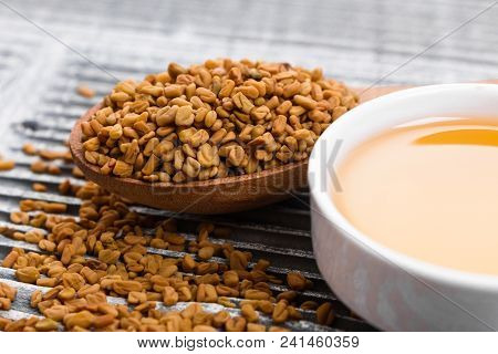 Fragrant Grains Of Fenugreek On A Rustic Background.