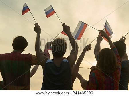 Crowd With Russian Flags. Evening Sunny Sky Background.