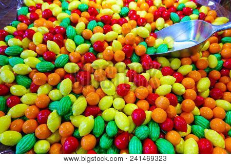 Closeup Photo Of Colorful Candies, Fruits In Red, Orange And Green Color
