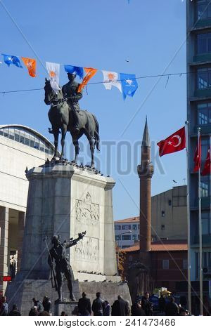 ANKARA, TURKEY - JANUARY 18, 2018: Flags of AK Party and Statue of Ataturk and a mosque minaret in Ulus, Ankara. The three symbols in Turkey symbolizes power struggle towards to Presidential elections