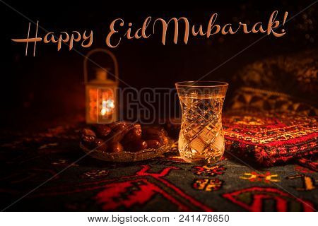 Water And Dates. Iftar Is The Evening Meal. View Of Decoration Ramadan Kareem Holiday On Carpet. Fes