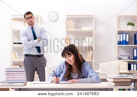 Male lecturer giving lecture to female student