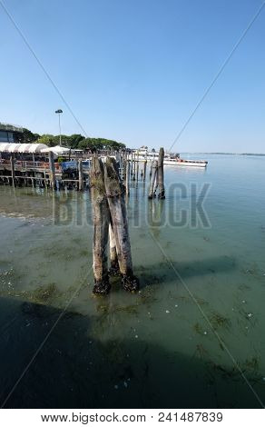 VENICE, ITALY - MAY 28 : Wooden mooring poles in the sea on the way from Lido di Jesolo to Venice, Italy, on May 28, 2017.